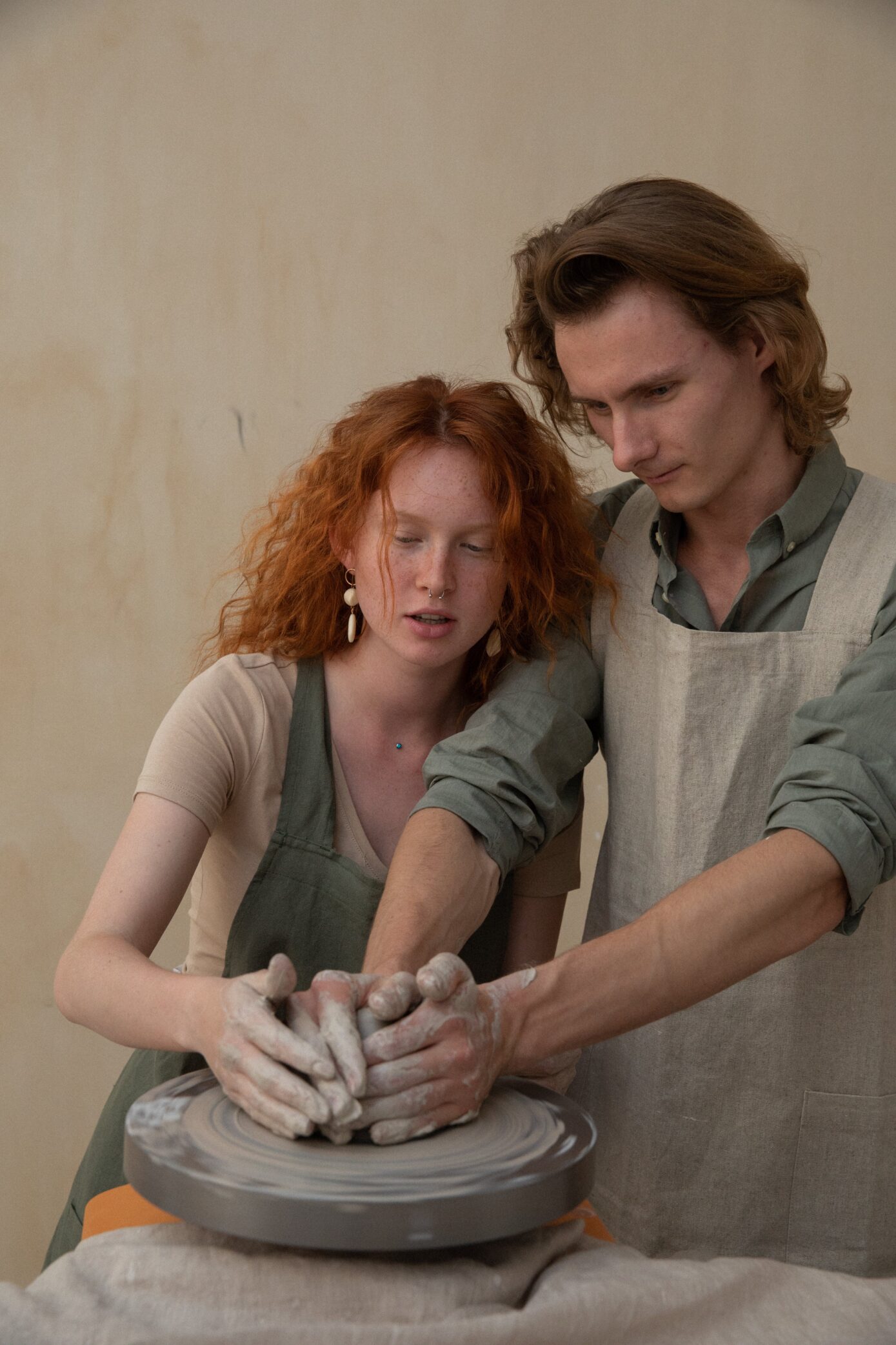 two people using pottery wheel